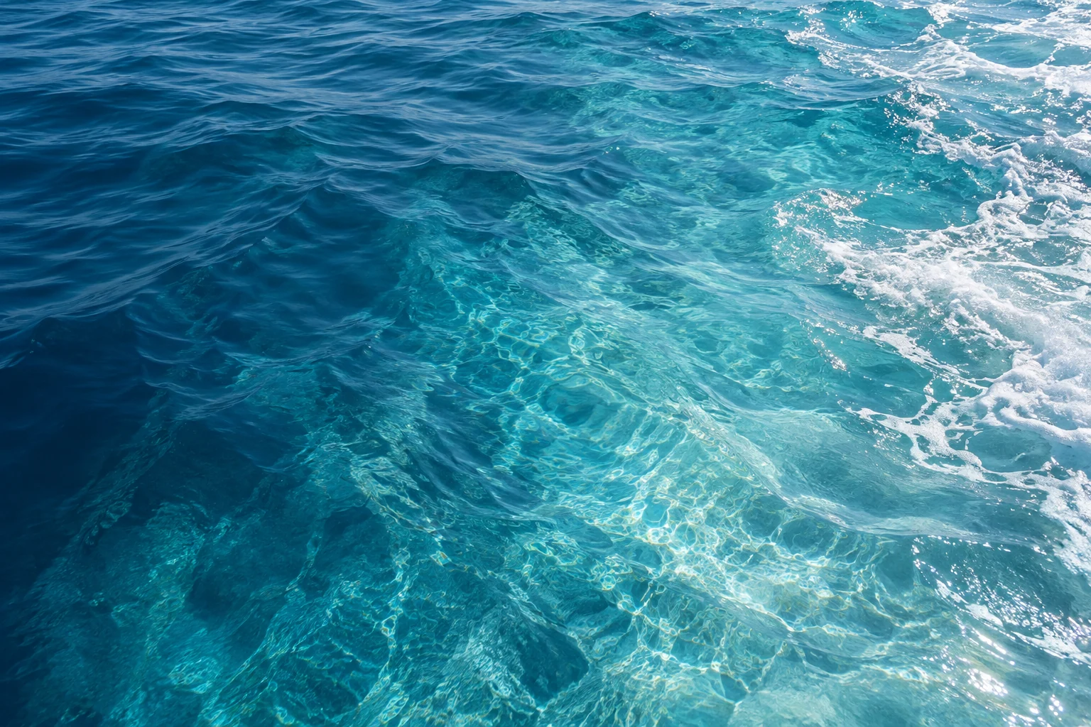 Sunlight moving across clear turquoise coastal water